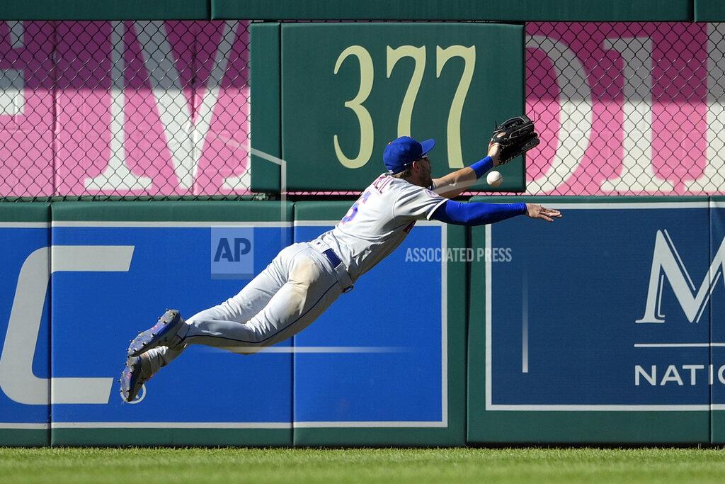 Nick Wass New York Mets left fielder Jeff McNeil (6) leaps but cannot get to a ball that went for a ground rule double for Washington Nationals' Carter Kieboom during the seventh inning of the first baseball game of a doubleheader, Saturday, Sept. 4, 2021, in Washington. The Mets won 11-9 in extra innings. (AP Photo/Nick Wass)