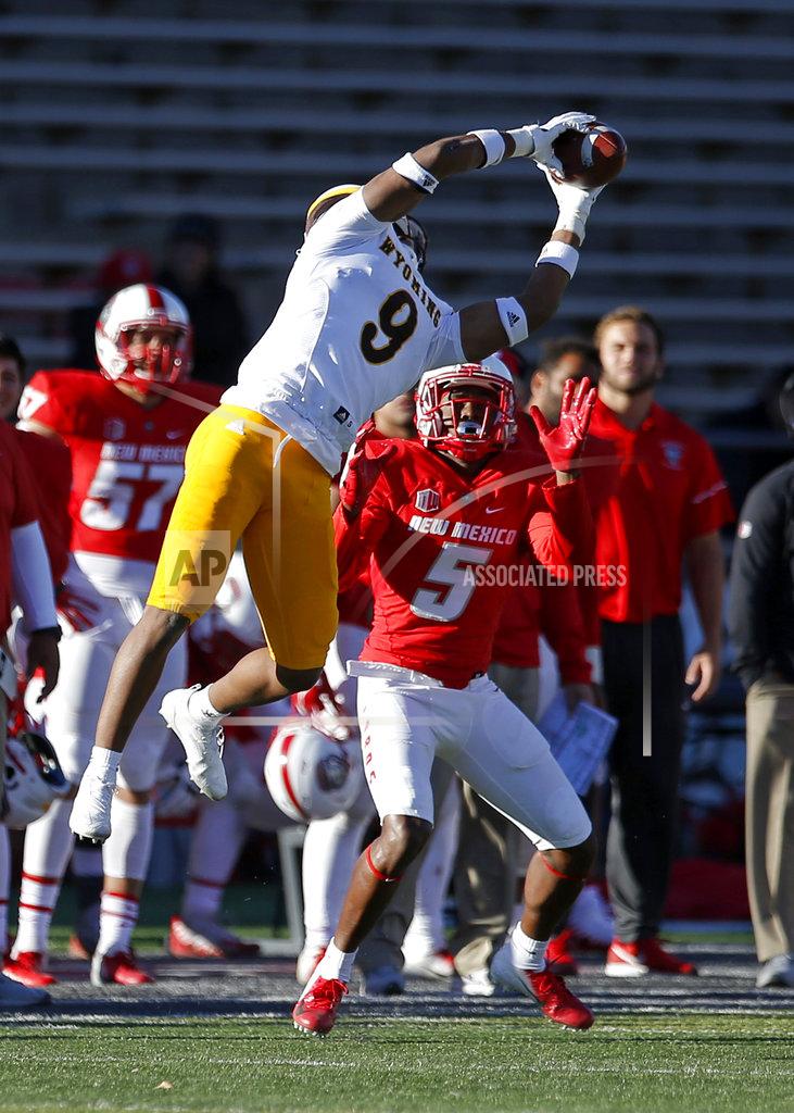 Andres Leighton Wyoming linebacker Tyler Hall (9) intercepts a pass intended for New Mexico wide receiver Patrick Reed (5) during the second half of an NCAA college football game in Albuquerque, N.M., Saturday, Nov. 24, 2018. Wyoming won 31-3. (AP Photo/Andres Leighton)