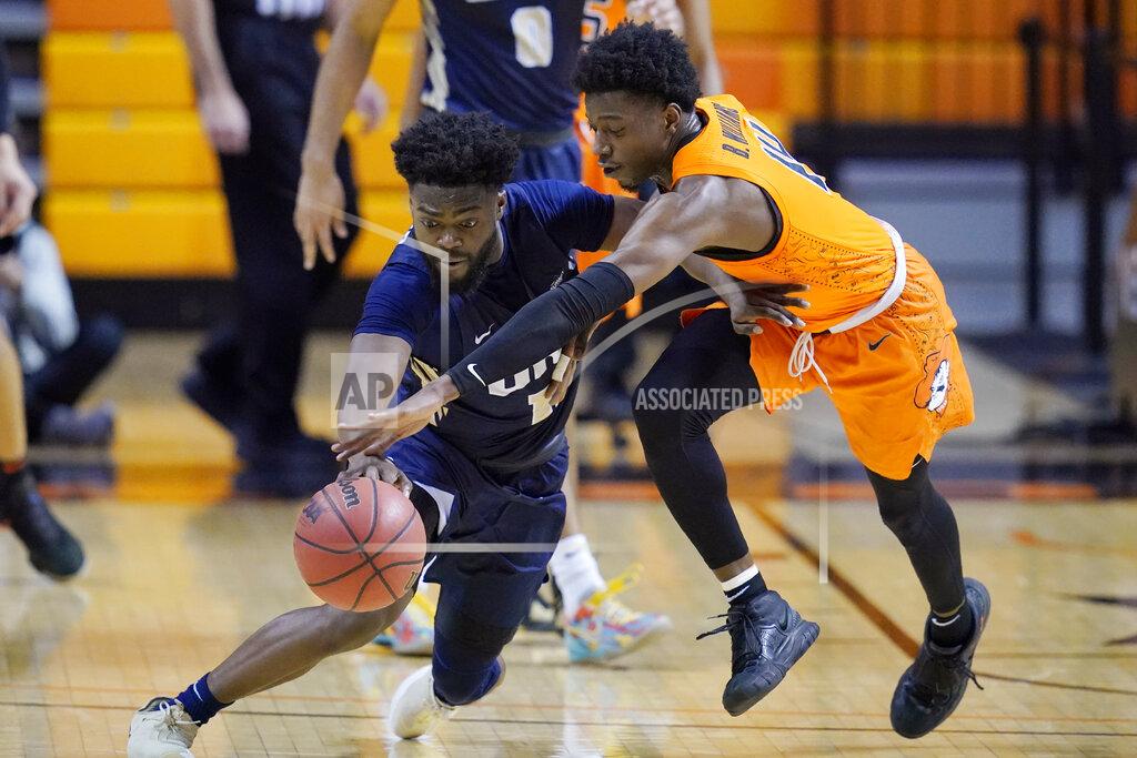 Sue Ogrocki Oral Roberts guard RJ Glasper, left, and Oklahoma State guard Bryce Williams reach for the ball during the second half of an NCAA college basketball game Tuesday, Dec. 8, 2020, in Stillwater, Okla. (AP Photo/Sue Ogrocki)