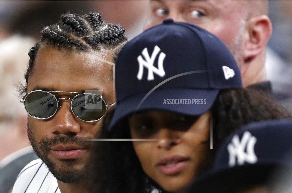 Kathy Willens Seattle Seahawks quarterback Russell Simmon, left, and his wife, singer Ciara, center, watch the New York Yankees' baseball game against the Houston Astros, Friday, June 21, 2019, in New York. (AP Photo/Kathy Willens)
