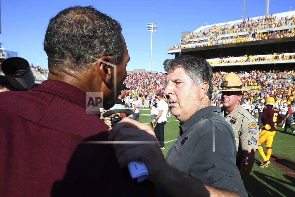 Ross D. Franklin Washington State head coach Mike Leach, right, talks with Arizona State head coach Herm Edwards, left, after an NCAA college football game Saturday, Oct. 12, 2019, in Tempe, Ariz. (AP Photo/Ross D. Franklin)