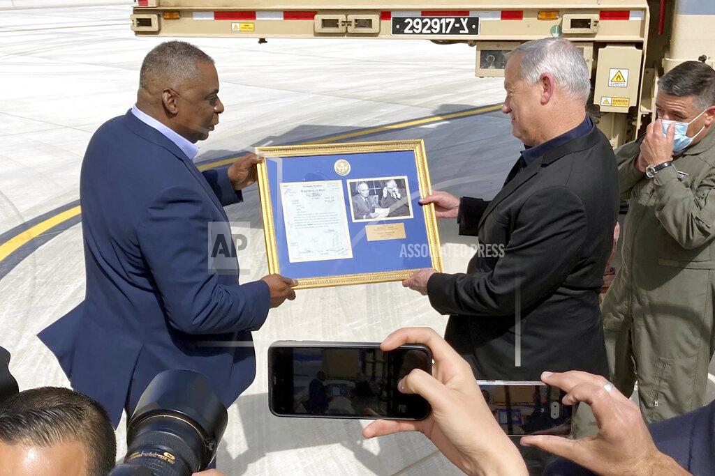 Robert Burns U.S. Defense Secretary Lloyd Austin, left, presents Israeli Defense Minister Benny Gantz, right, with a framed copy of a formerly Top Secret memo regarding U.S. consideration of granting official recognition of the state of Israel shortly after its creation in 1948, at Nevatim Israeli Air Force Base, Monday, April 12, 2021 in Israel. The inset photo on right shows President Truman and Secretary of State George Marshall. (AP Photo/Robert Burns)