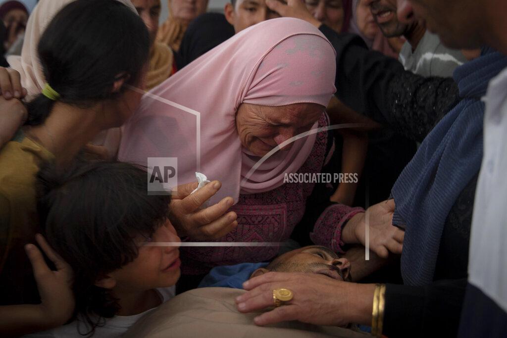 Majdi Mohammed A Palestinian woman mourns while taking a last look at the body of Raed Jadallah, 39, who was killed by Israeli forces at the western entrance of his village while returning from work in the early hours of Wednesday morning, during his funeral, in the West Bank village of Beit Ur al-Tahta, Wednesday, Sep. 1, 2021. (AP Photo/Majdi Mohammed)