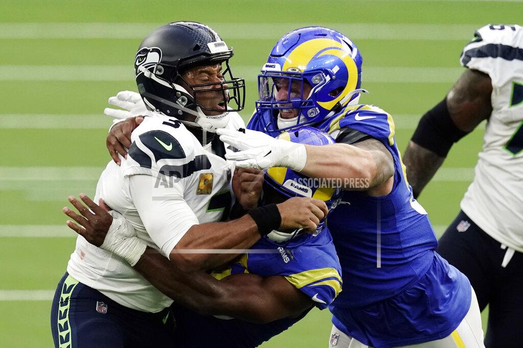 Jae C. Hong Seattle Seahawks quarterback Russell Wilson (3) is tackled by two against the Los Angeles Rams defenders during the second half of an NFL football game Sunday, Nov. 15, 2020, in Inglewood, Calif. (AP Photo/Jae C. Hong )