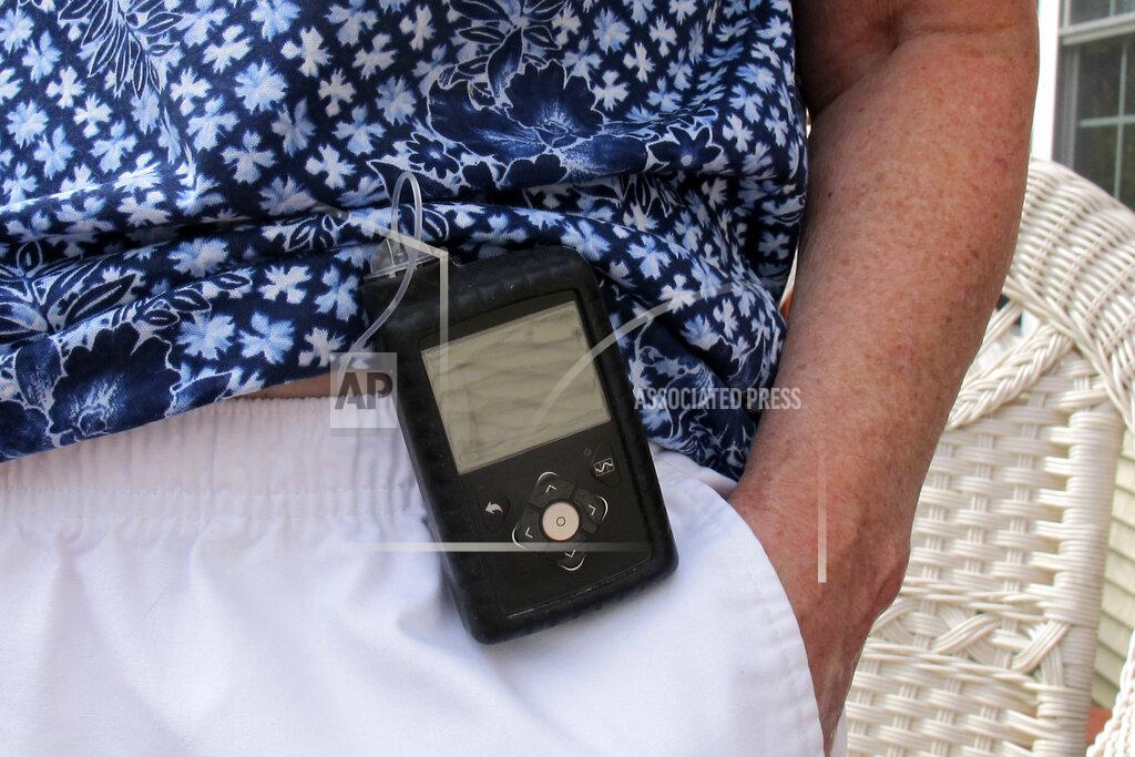 In this Aug. 24, 2020, photo Jean Grady wears an insulin pump to help manage her diabetes at her home in Westford, Vt. Before the pandemic, Medicare rules required her make regular two-hour, one-way trips to New Hampshire to meet with her doctor to discuss her treatment. Medicare rule changes during the pandemic now makes it possible for her to meet with her doctor remotely, saving her from hours on the road. (AP Photo/Wilson Ring)
