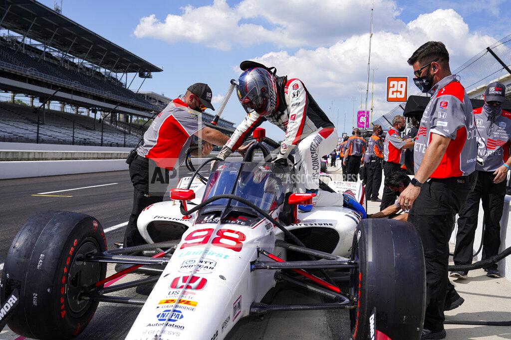 Michael Conroy Marco Andretti climbs into his car during practice for the Indianapolis 500 auto race at Indianapolis Motor Speedway in Indianapolis, Friday, Aug. 14, 2020. (AP Photo/Michael Conroy)