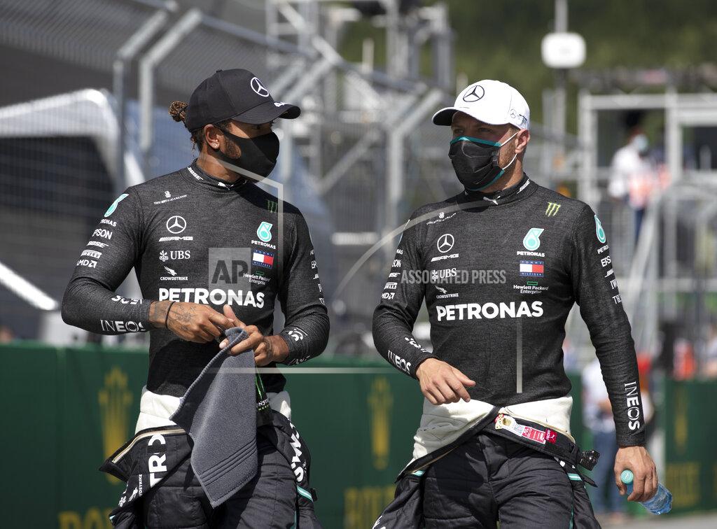 Mark Thompson Mercedes driver Valtteri Bottas of Finland, right speaks with second placed Mercedes driver Lewis Hamilton of Britain after he clocked the fastest time during the qualifying session at the Red Bull Ring racetrack in Spielberg, Austria, Saturday, July 4, 2020. The Austrian Formula One Grand Prix will be held on Sunday. (Mark Thompson/Pool via AP)