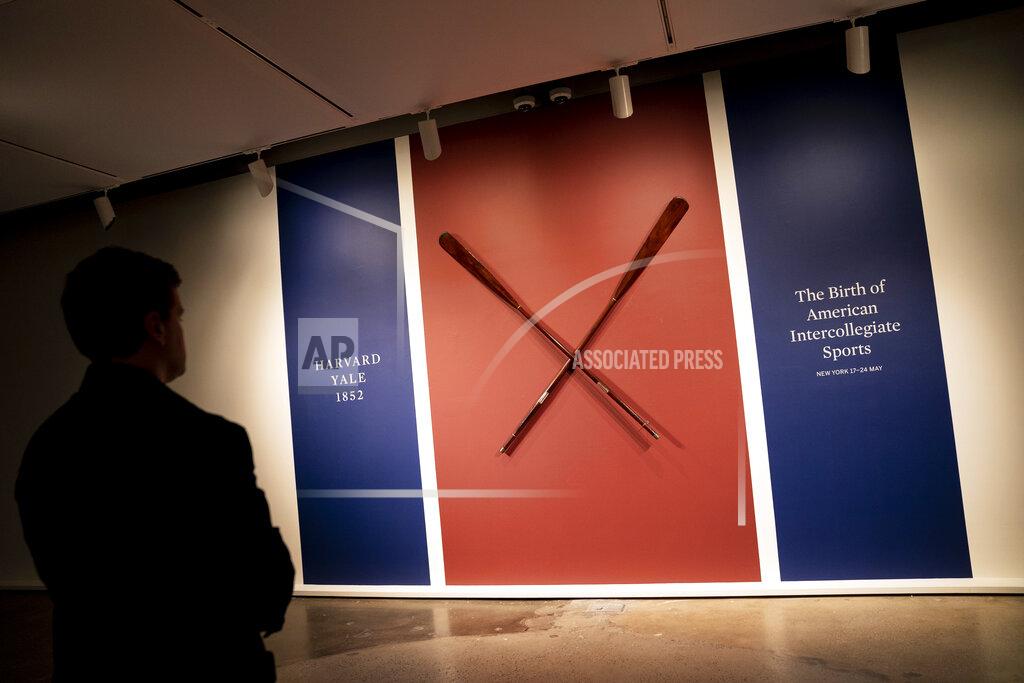 John Minchillo The Harvard-Yale Regatta 1852 Trophy Oars are displayed before an auction, Thursday, April 21, 2022, at Sotheby's in the Manhattan borough of New York. Sotheby's estimates the oars value between three and five million dollars. The oars were awarded to Harvard's winning crew and represent one of the oldest collegiate athletic competitions in the nation's history. (AP Photo/John Minchillo)