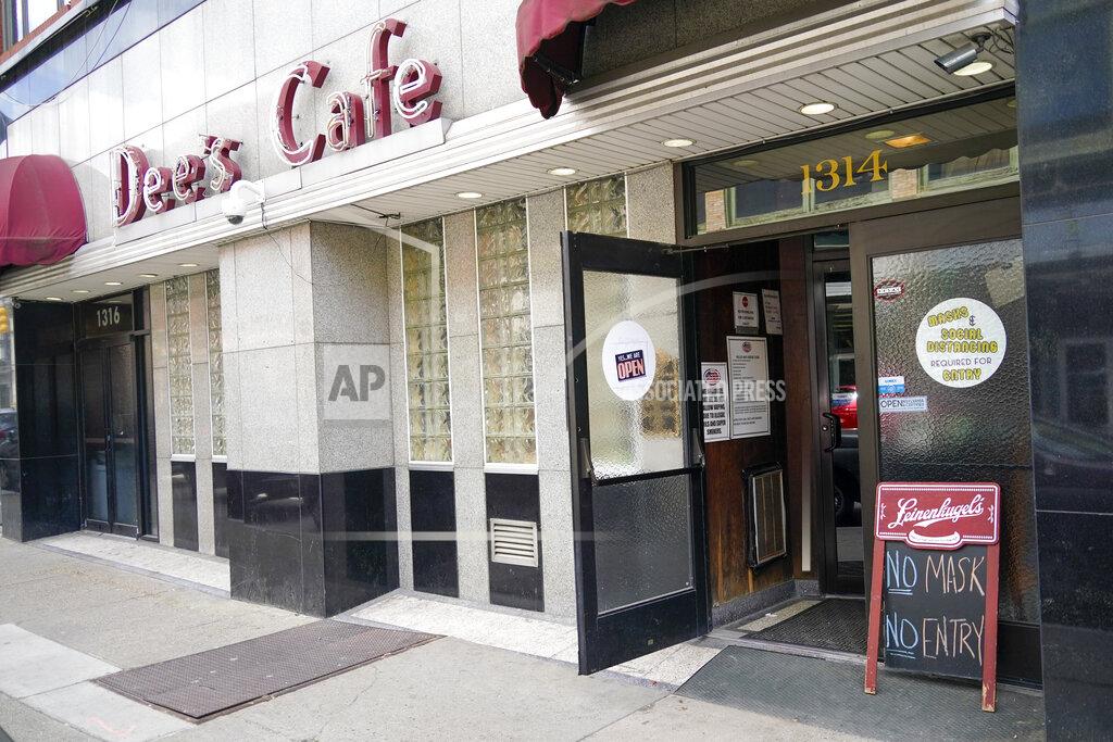 Keith Srakocic A sign requiring a COVID-19 protective mask is required to enter is in front of Dee's Cafe, Friday, May 14, 2021, in Pittsburgh's South Side neighborhood. (AP Photo/Keith Srakocic)