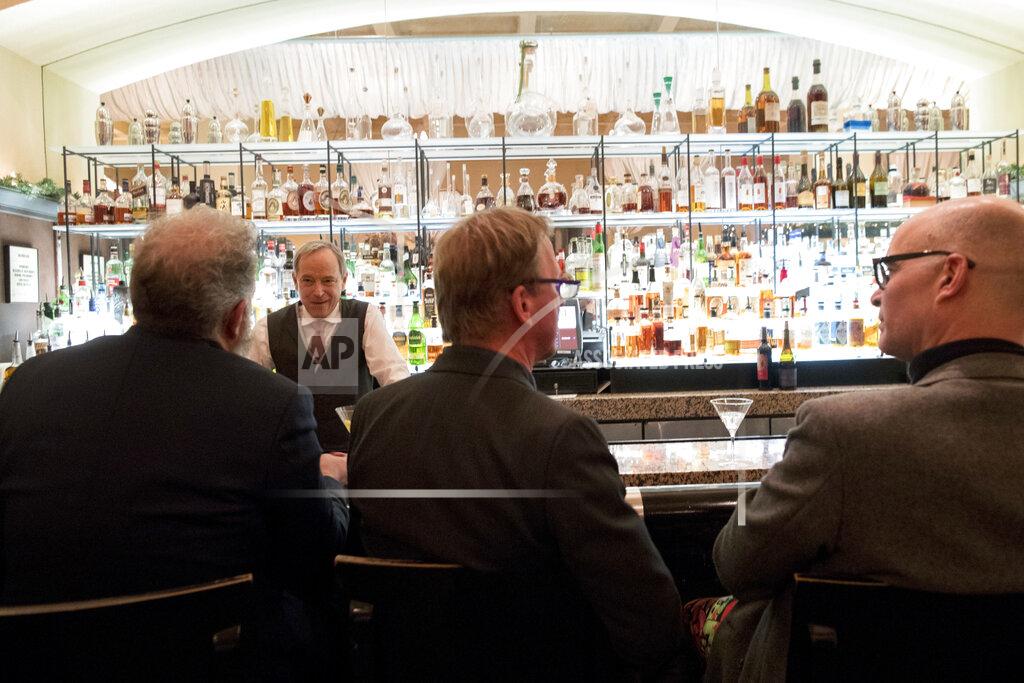 In this Tuesday, Nov. 27, 2018, photo, a bartender talks to a customer at the Gotham Bar and Grill in New York. The Manhattan upscale restaurant hopes to reopen by summer 2021 if government regulations permit, but will likely have just 35 staffers instead of the 100 the restaurant had before it closed in March 2020. (AP Photo/Mary Altaffer)