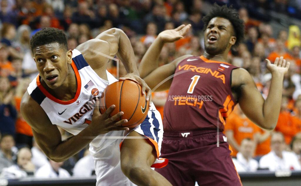 Steve Helber Virginia guard De'Andre Hunter (12) drives top the basket as he gets around Virginia Tech guard Isaiah Wilkins (1) during the first half of an NCAA college basketball game in Charlottesville, Va., Tuesday, Jan. 15, 2019. (AP Photo/Steve Helber)