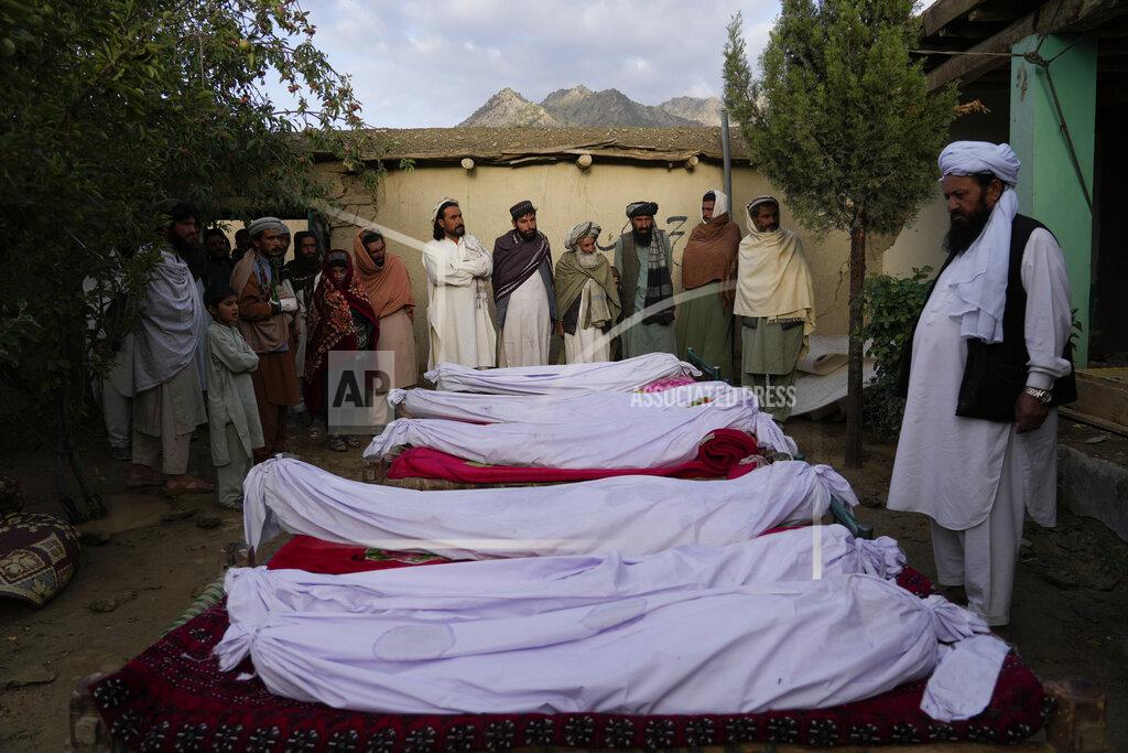 Ebrahim Noroozi Men stand around the bodies of people killed in an earthquake in Gayan village, in Paktika province, Afghanistan, Thursday, June 23, 2022. A powerful earthquake struck a rugged, mountainous region of eastern Afghanistan early Wednesday, flattening stone and mud-brick homes in the country's deadliest quake in two decades, the state-run news agency reported. (AP Photo/Ebrahim Nooroozi)