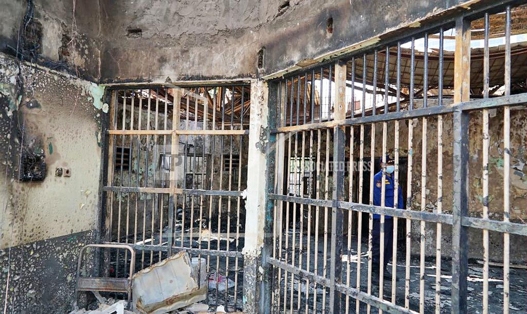Indonesian Ministry Of Justice In this photo released by Indonesian Ministry of Justice and Human Rights, a fireman stands inside a charred cell after a fire at Tangerang Prison in Tangerang, Indonesia, Wednesday, Sept. 8, 2021. A massive fire raged through the overcrowded prison near Indonesia's capital early Wednesday, killing a number of inmates. (Indonesian Ministry of Justice and Human Rights via AP)