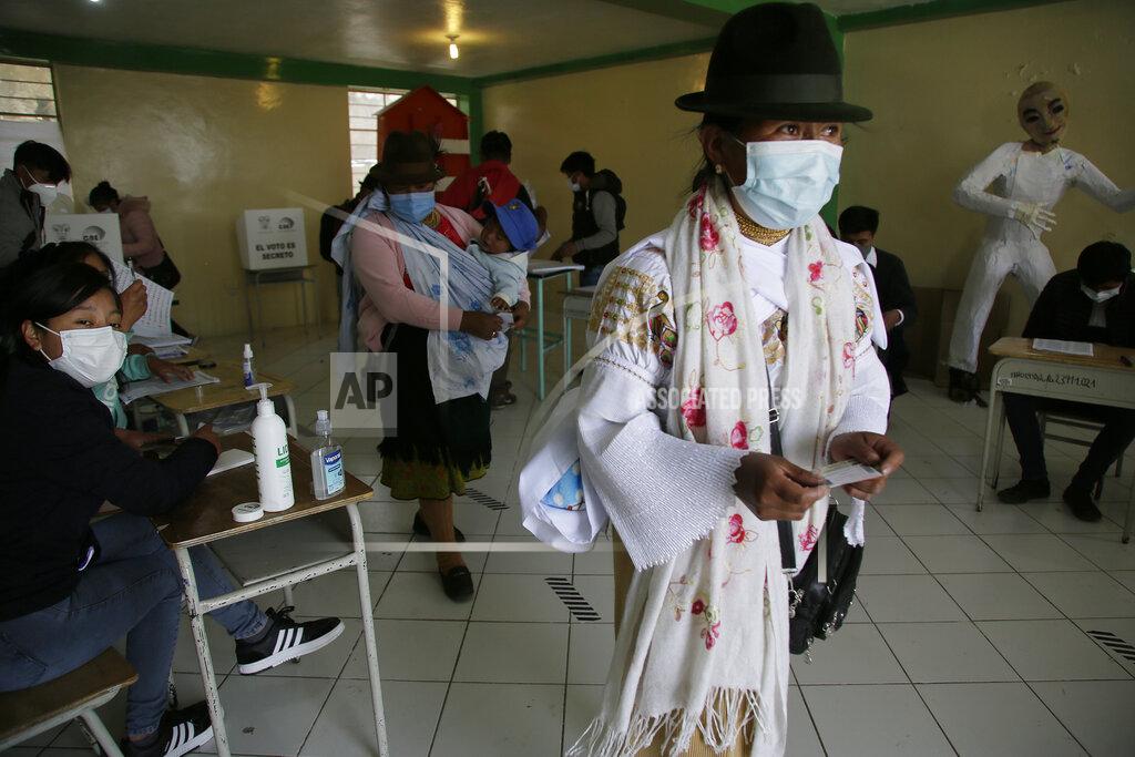 Dolores Ochoa A woman leaves a polling station casting her ballot in a general election, in Cangahua, Ecuador, Sunday, Feb. 7, 2021. Amidst the new coronavirus pandemic, Ecuadoreans went to the polls in a first-round presidential and legislative election. (AP Photo/Dolores Ochoa)