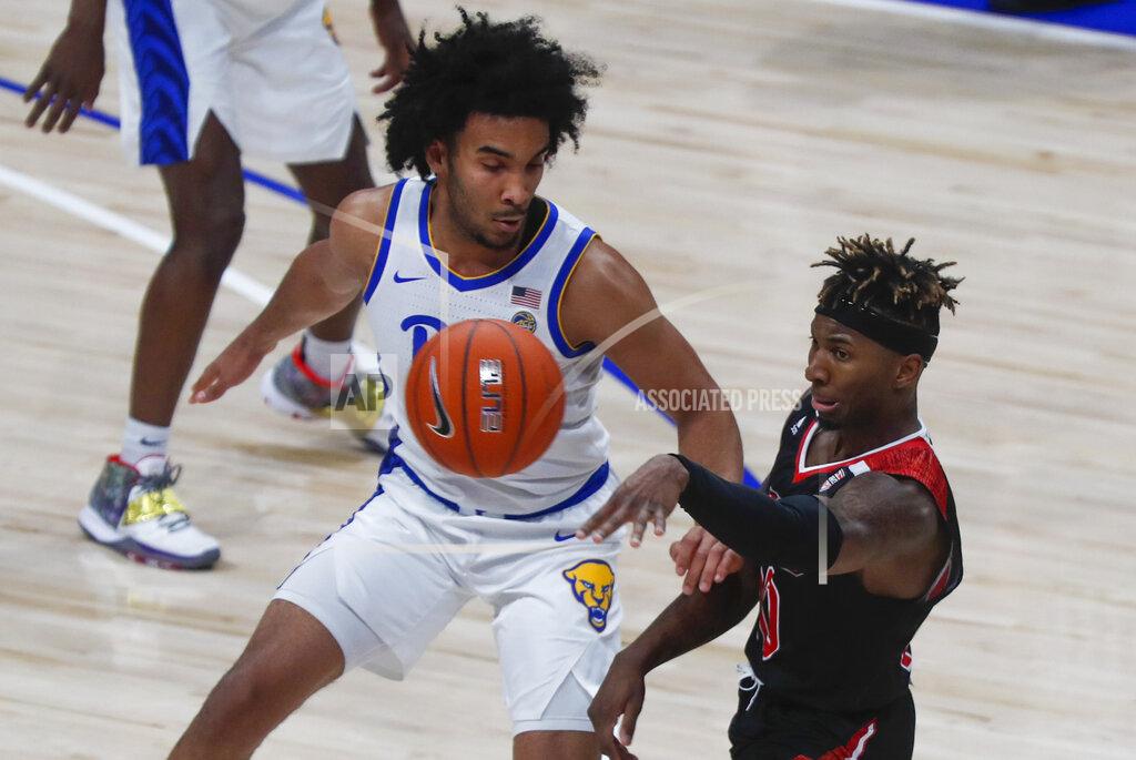 Keith Srakocic Northern Illinois's Eugene German, right, passes past Pittsburgh's Justin Champagnie during the second half of an NCAA college basketball game, Monday, Dec. 16, 2019, in Pittsburgh. Pittsburgh won 59-50. (AP Photo/Keith Srakocic)