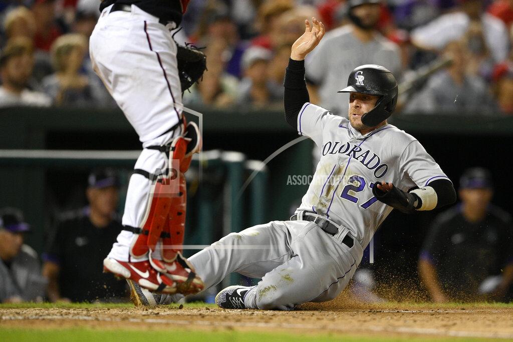 Nick Wass Colorado Rockies' Trevor Story (27) slides home to score on a single by Ryan McMahon during the sixth inning of a baseball game against the Washington Nationals, Friday, Sept. 17, 2021, in Washington. (AP Photo/Nick Wass)
