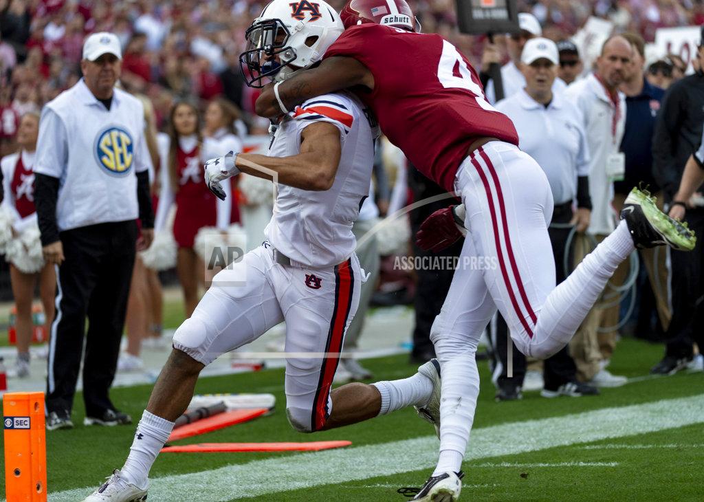 Vasha Hunt Auburn wide receiver Anthony Schwartz (5) scores his team's first touchdown as he is hit by Alabama defensive back Saivion Smith (4) during the first half of an NCAA college football game, Saturday, Nov. 24, 2018, in Tuscaloosa, Ala. (AP Photo/Vasha Hunt)