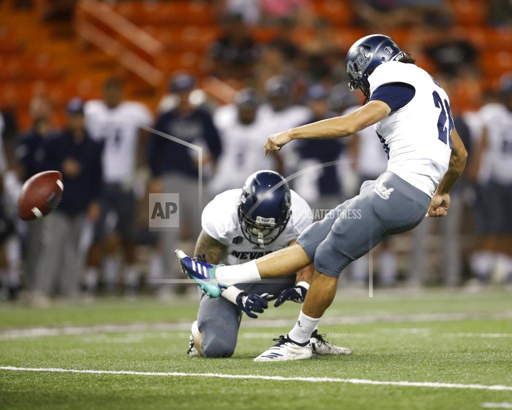 Marco Garcia Nevada wide receiver Kaleb Fossum (3) holds the ball as Nevada place kicker Ramiz Ahmed (26) makes a field goal against Hawaii during the second quarter of an NCAA college football game Saturday, Oct. 20, 2018, in Honolulu. (AP Photo/Marco Garcia)