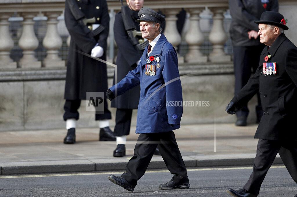 Peter Nicholls D-Day veteran John Aichison, 96, centre, attends the Remembrance Sunday service at the Cenotaph, in Whitehall, London, Sunday Nov. 8, 2020. (Peter Nicholls/Pool Photo via AP)
