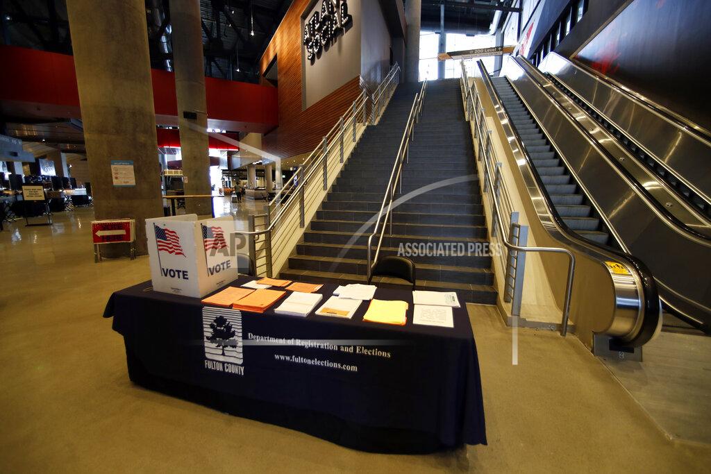 John Bazemore Voting equipment is shown during a media tour of State Farm Arena, home of the NBA's Atlanta Hawks basketball team, Friday, July 17, 2020, in Atlanta. The 16,888-seat facility will be used as a poll location for the upcoming election. (AP Photo/John Bazemore)