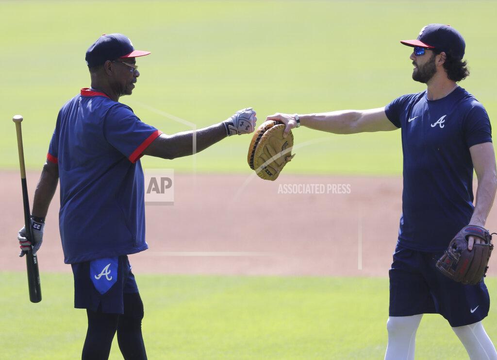 Brynn Anderson Atlanta Braves' Dansby Swanson fist bumps coach Ron Washington during team practice at Truist Park on Sunday, July 5, 2020, in Atlanta. (AP Photo/Brynn Anderson)