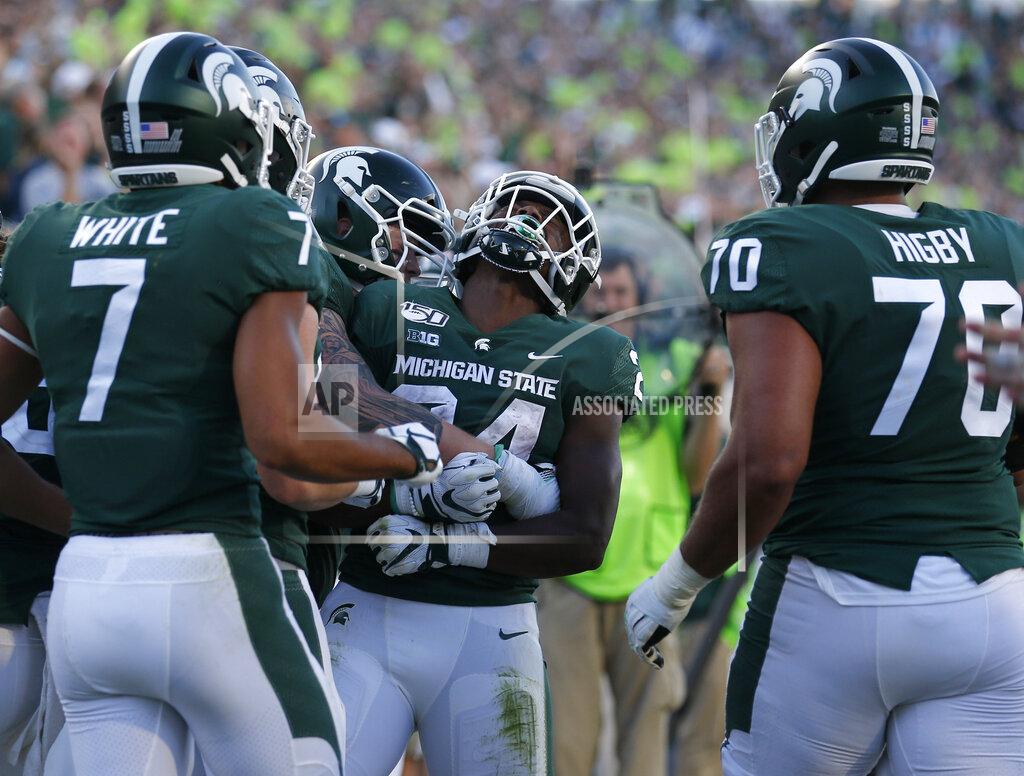 Al Goldis Michigan State's Elijah Collins, center, celebrates his rushing touchdown with teammates during the fourth quarter of an NCAA college football game against Arizona State, Saturday, Sept. 14, 2019, in East Lansing, Mich. (AP Photo/Al Goldis)