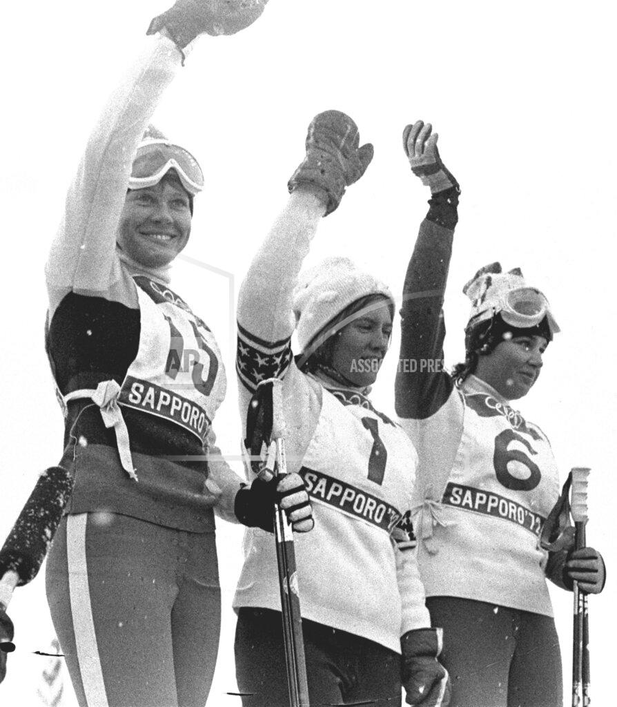Sal Veder FILE - Barbara Ann Cochran, center, of the United States, winner of the Winter Olympic women's slalom gold medal, stands with Florence Steurer (15), the bronze medalist, and Daniele Debernard (6) the silver medalist both from France, in Sapporo, Japan on Feb. 11, 1972. Fifty years after his mom, Barbara Ann, won the gold in slalom, Ryan Cochran-Siegle is contending for a medal in the men's downhill that will open the Alpine skiing program of the Beijing Games on Sunday.(AP Photo/ Sal Veder, File)