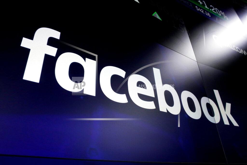 FILE - This March 29, 2018, file photo shows the Facebook logo on screens at the Nasdaq MarketSite in New York's Times Square. Facebook on Tuesday, April 28, 2020, reported its slowest quarterly growth as a public company, pressured by a global slowdown in the digital advertising market due to the coronavirus pandemic. (AP Photo/Richard Drew, File)