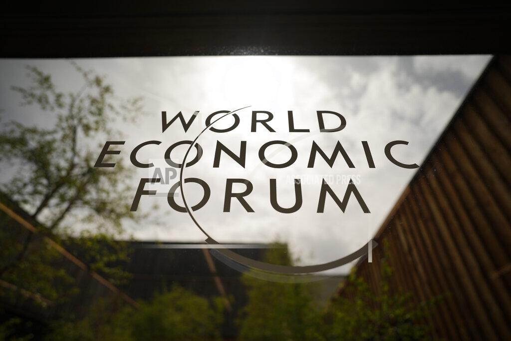 Markus Schreiber The logo of the World Economy Forum is displayed at a window of the venue prior to the opening of the event in Davos, Switzerland, Sunday, May 22, 2022. The annual meeting of the World Economy Forum is taking place in Davos from May. 22 until May. 26, 2020. (AP Photo/Markus Schreiber)