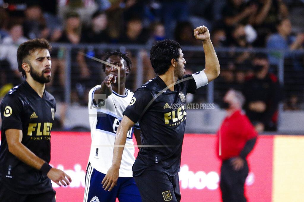 Ringo H.W. Chiu Los Angeles FC forward Carlos Vela, right, celebrates his goal during the first half of the team's MLS soccer match against the Vancouver Whitecaps in Los Angeles, Saturday, July 24, 2021. (AP Photo/Ringo H.W. Chiu)