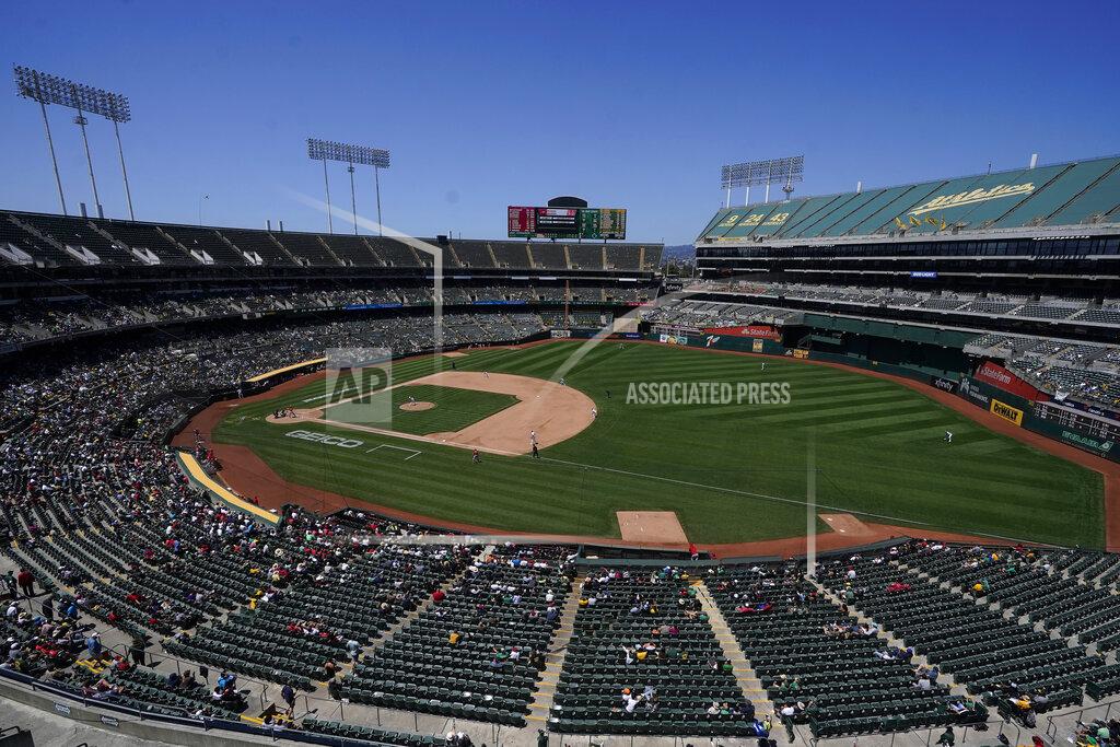Jeff Chiu Fans watch as Oakland Athletics' James Kaprielian pitches to a Los Angeles Angels batter during the sixth inning of a baseball game in Oakland, Calif., Tuesday, July 20, 2021. The Oakland City Council approved on Tuesday preliminary terms for a new $12 billion waterfront ballpark project for the Athletics. But it's not clear if the 6-1 vote will be enough to keep the A's at the negotiating table instead of leaving the city. (AP Photo/Jeff Chiu. File)