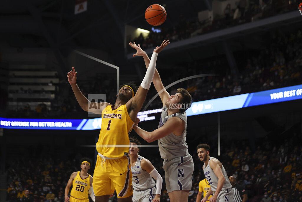 Stacy Bengs Minnesota forward Eric Curry (1) and Northwestern center Ryan Young, front right, go after the ball during the first half of an NCAA college basketball game Saturday, Feb. 19, 2022, in Minneapolis. (AP Photo/Stacy Bengs)