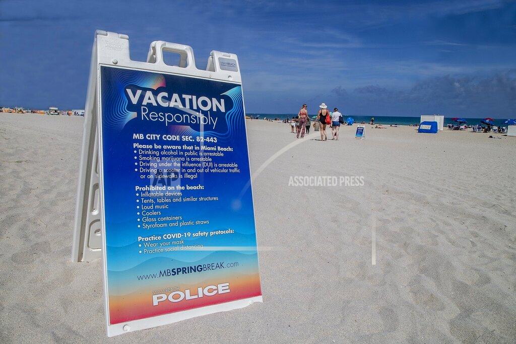 City of Miami Beach have placed signs along the beach as part of the Miami Beach Vacation Responsibly campaign advising spring breakers of the zero tolerance rules, Tuesday, March 2, 2021 in Miami Beach, Fla. Miami Beach officials are imposing an emergency 8 p.m.-6 a.m. curfew effective immediately, saying large, out-of-control spring break crowds crammed the beaches, trashed some restaurant properties and brawled in the streets. Tourists and hotel guests are being told to stay indoors during the curfew hours. (Pedro Portal/Miami Herald via AP)