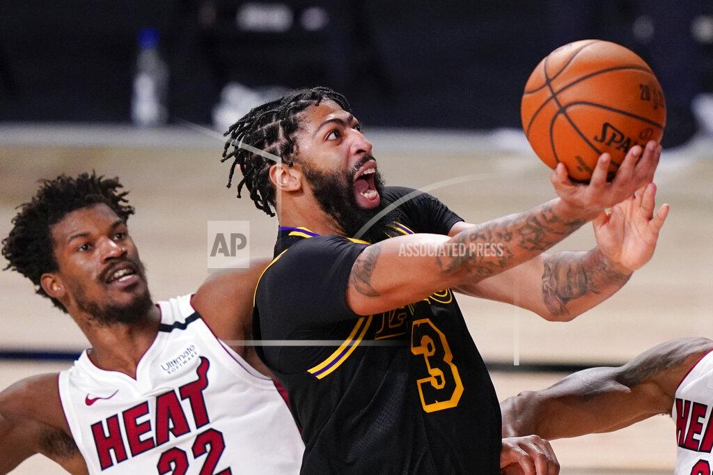 Mark J. Terrill FILE - In this Oct. 9, 2020, file photo, Los Angeles Lakers forward Anthony Davis shoots past Miami Heat forward Jimmy Butler during the second half in Game 5 of basketball's NBA Finals in Lake Buena Vista, Fla. Davis is the biggest name on the free agency board; he turned down his option for this season with the Lakers but isn’t expected to go anyplace else. (AP Photo/Mark J. Terrill, File)