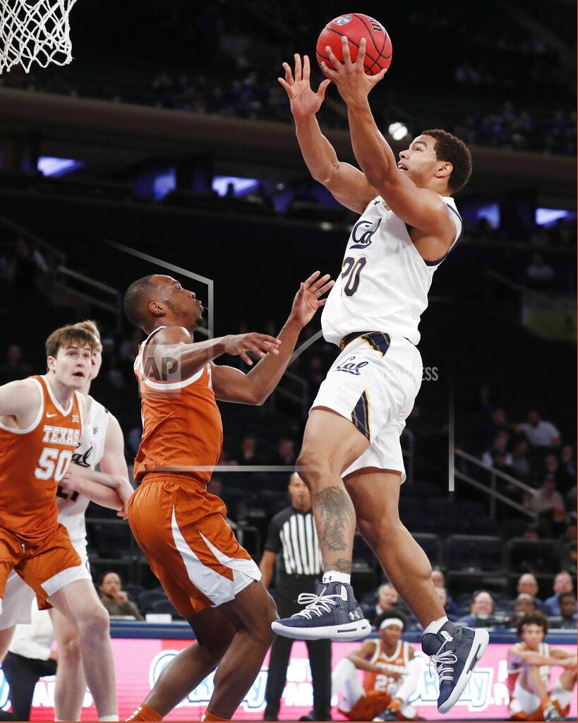 Kathy Willens Texas guard Matt Coleman III, second from left, watches as California guard Matt Bradley (20) goes up for a layup with Texas center Will Baker (50) watching during the first half of an NCAA college basketball game in the 2K Empire Classic, Friday, Nov. 22, 2019, in New York. (AP Photo/Kathy Willens)