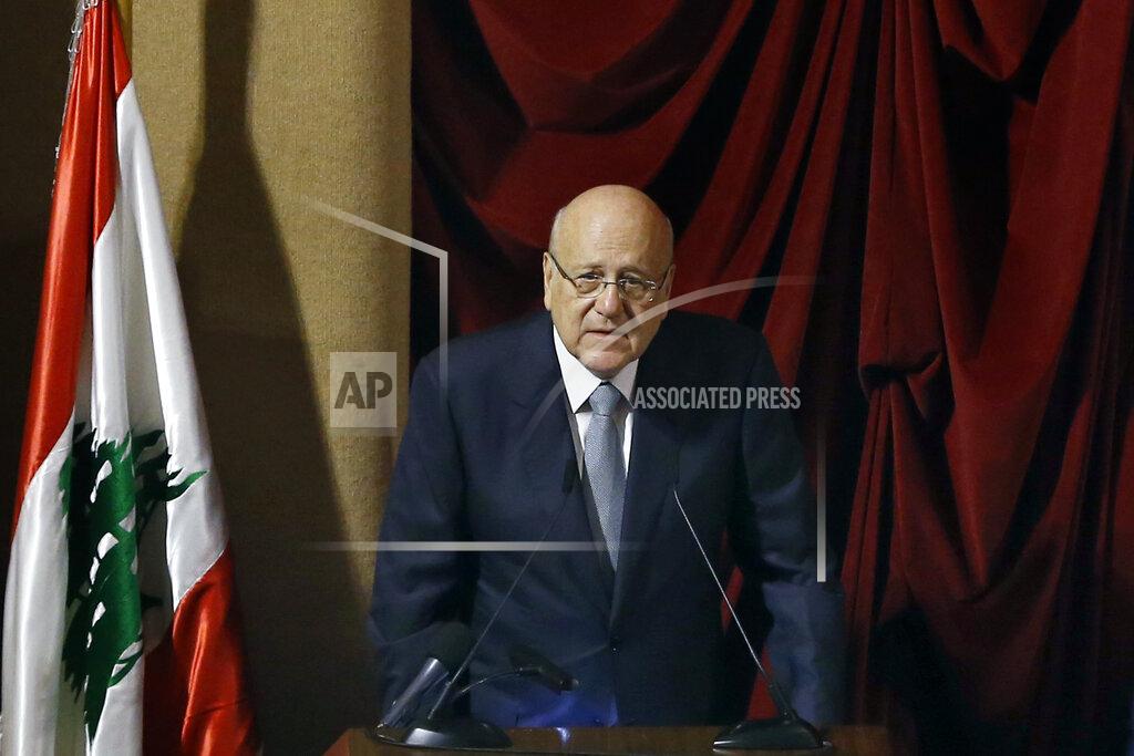 Bilal Hussein Lebanese Prime Minister Najib Mikati speaks during a parliament session to confirm Lebanon's new government at a Beirut theater known as the UNESCO palace so that parliament members could observe social distancing measures imposed over the coronavirus pandemic, Lebanon, Monday, Sept. 20, 2021. A power outage and a broken generator briefly delayed the start of the parliament session for some 40 minutes before electricity came back on. (AP Photo/Bilal Hussein)