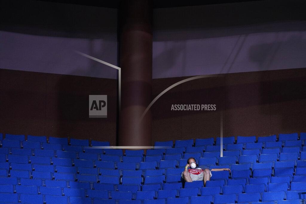 Evan Vucci FILE - In this June 20, 2020, file photo, a supporter of President Donald Trump sits in the stands wearing a face mask during a campaign rally at the BOK Center in Tulsa, Okla. (AP Photo/Evan Vucci, File)