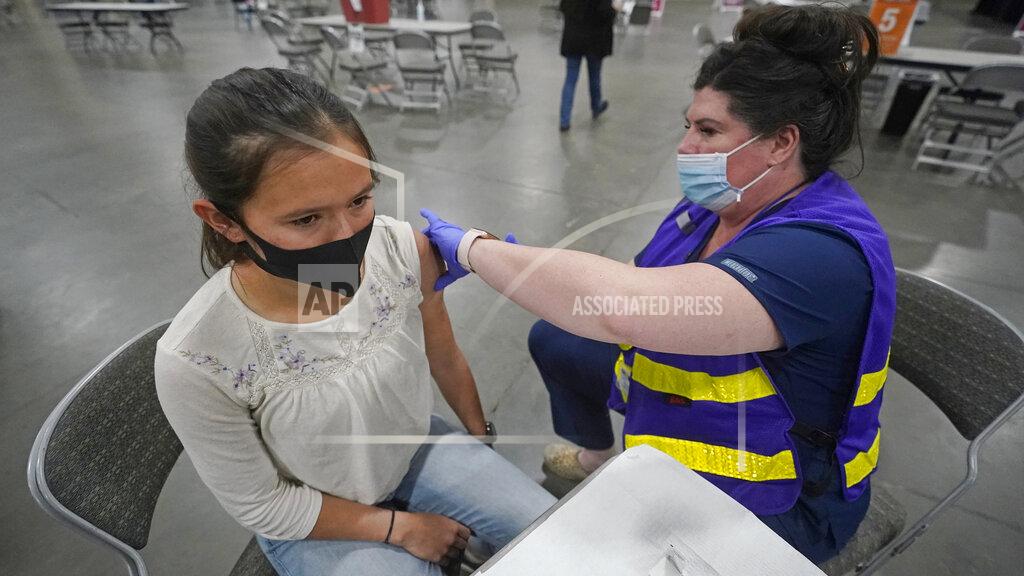Rick Bowmer Allison Oler, 17, receives her Pfizer vaccination, Wednesday, March 24, 2021, in Sandy, Utah. All adults in Utah aged 16 and older became eligible to receive COVID-19 vaccinations Wednesday. (AP Photo/Rick Bowmer)