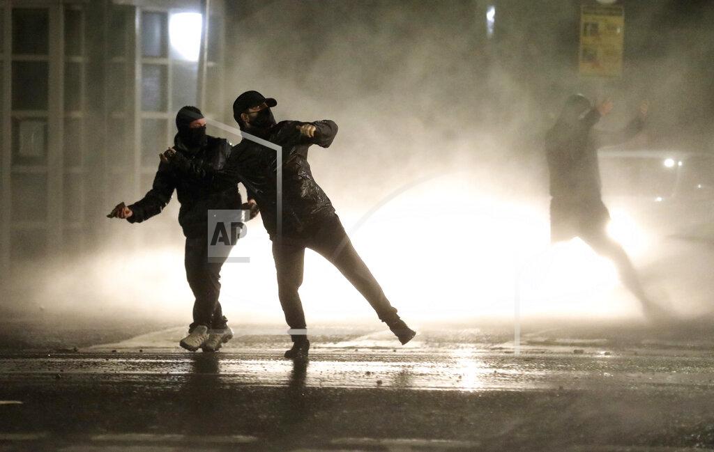 Peter Morrison Nationalist youths confront police lines near the Peace Wall in West Belfast, Northern Ireland, Thursday, April 8, 2021. Authorities in Northern Ireland sought to restore calm Thursday after Protestant and Catholic youths in Belfast hurled bricks, fireworks and gasoline bombs at police and each other. It was the worst mayhem in a week of street violence in the region, where Britain's exit from the European Union has unsettled an uneasy political balance. (AP Photo/Peter Morrison)