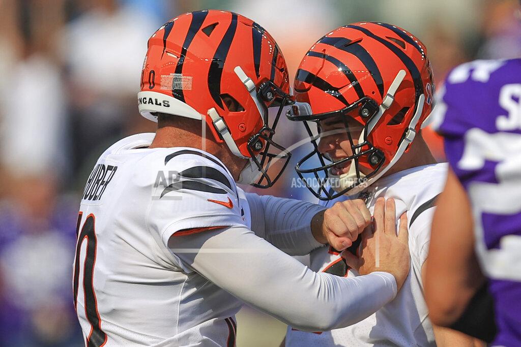 Cincinnati Bengals kicker Evan McPherson, right, celebrates with holder Kevin Huber, left, after making a field goal to defeat the Minnesota Vikings during overtime of an NFL football game, Sunday, Sept. 12, 2021, in Cincinnati. (AP Photo/Aaron Doster)