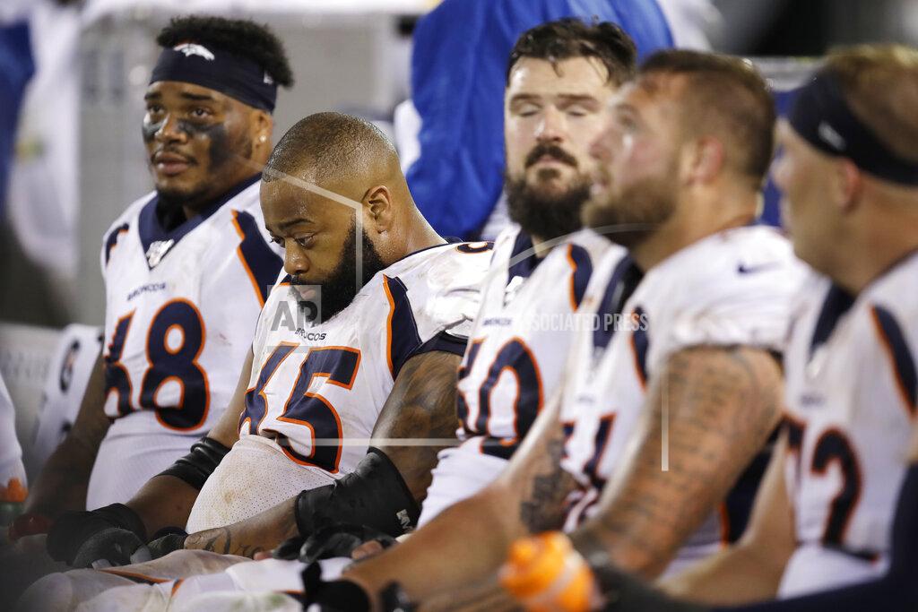 Ben Margot Denver Broncos offensive tackle Elijah Wilkinson (68), offensive guard Ronald Leary (65) and others sit on the bench during the second half of an NFL football game against the Oakland Raiders Monday, Sept. 9, 2019, in Oakland, Calif. Oakland won the game 24-16. (AP Photo/Ben Margot)