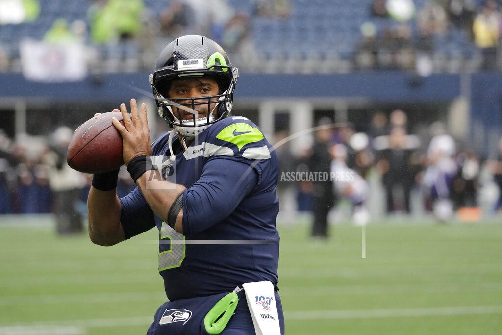 Elaine Thompson Seattle Seahawks quarterback Russell Wilson passes during warmups before an NFL football game against the Baltimore Ravens, Sunday, Oct. 20, 2019, in Seattle. (AP Photo/Elaine Thompson)