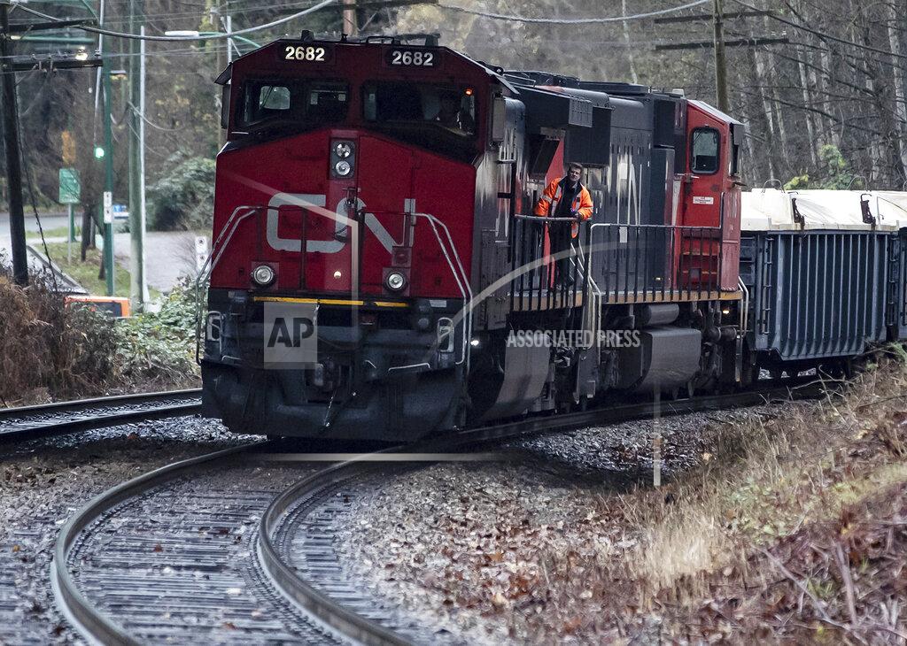 Darryl Dyck FILE - In this Nov. 27, 2020 file photo, a Canadian National rail worker stands on an idle locomotive as protesters opposed to the Trans Mountain pipeline expansion block rail lines in Burnaby, British Columbia,. The path is now clear for Canadian Pacific’s $31 billion acquisition of Kansas City Southern railroad to move forward after Canadian National dropped out of the bidding war Wednesday, Sept. 15, 2021. (Darryl Dyck/The Canadian Press via AP, File)