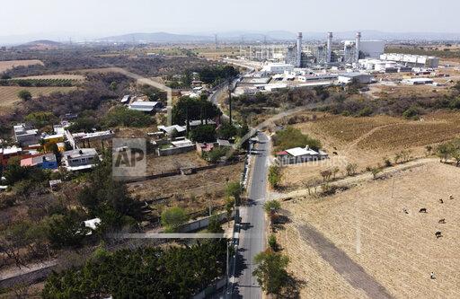FILE - In this Feb. 22, 2020 file photo, a power generation plant stands idle near Huexca, Morelos state, Mexico. A constitutional reform presented by President Andrés Manuel López Obrador would cancel contracts under which some private power generating plants plants sell power into the national grid, declares “illegal” other private plants that sell energy direct to corporate clients in Mexico and would cancel many long-term energy supply contracts and clean-energy preferential buying schemes. (AP Photo/Eduardo Verdugo, File)