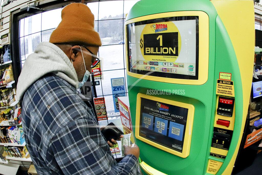 Keith Srakocic A patron, who did not want to give his name, uses the lottery ticket vending kiosk at a Smoker Friendly store to purchase tickets for the Mega Millions lottery drawing, Friday, Jan. 22, 2021, in Cranberry Township, Pa. The jackpot for the Mega Millions lottery game has grown to $1 billion ahead of Friday night's drawing after more than four months without a winner. (AP Photo/Keith Srakocic)