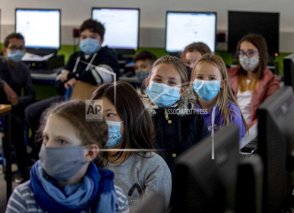 Michael Probst FILE - In this Oct. 21, 2020 file photo, pupils of a fifth class at a high school wear face masks as they take part in an electronic learning session in Frankfurt, Germany. More than 50,000 people have died after contracting COVID-19 in Germany, a number that has risen swiftly over recent weeks as the country has struggled to bring down infection figures. (AP Photo/Michael Probst, File)