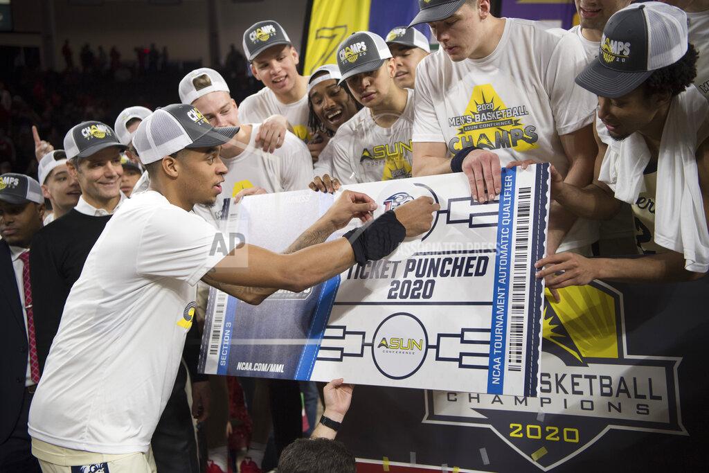 Lee Luther Jr. Liberty guard Caleb Homesley places a Liberty Flames sticker to complete the ASUN bracket after defeating Lipscomb in the Atlantic Sun Conference NCAA basketball championship game in Lynchburg, Va., Sunday, March 8, 2020. (AP Photo/Lee Luther Jr.)