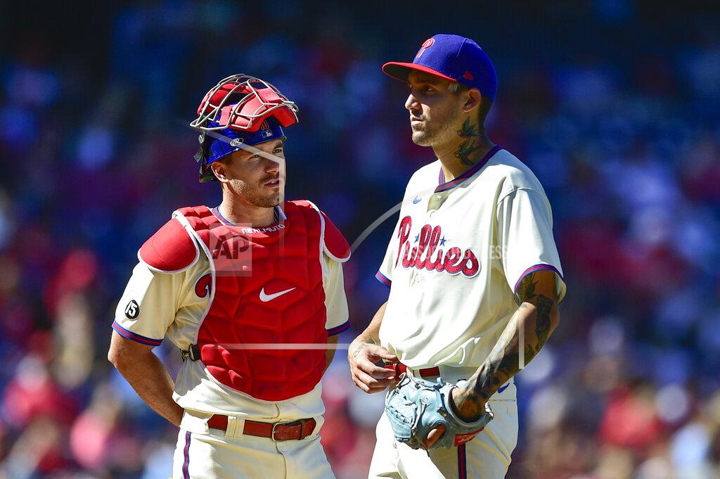 Derik Hamilton Philadelphia Phillies' J.T. Realmuto, left, talks to staring pitcher Hans Crouse during the third inning of a baseball game against the Pittsburgh Pirates, Sunday, Sept. 26, 2021, in Philadelphia. (AP Photo/Derik Hamilton)