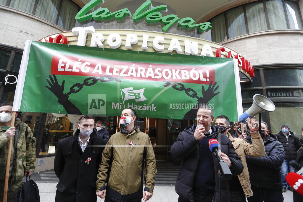 Laszlo Balogh FILE - In this Monday, March 15, 2021 file photo, Hungarians hold a banner that reads "Stop the Restrictions" during a protest in Budapest, Hungary. Poland has recorded a record high number of new daily coronavirus infections for the second day in a row. The 34,000 new cases on Thursday, March 25, 2021 are more than 4,000 more than the record reported a day earlier. Hungary also reported a record number of new deaths. In Poland officials say the deadly surge is driven by the highly contagious virus variant first detected in Britain, which now makes up most of the new cases. (AP Photo/Laszlo Balogh, File)