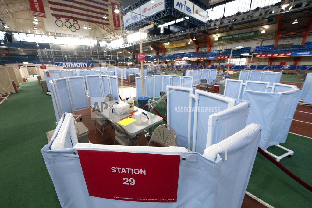 Mark Lennihan The Armory, an indoor track and field complex, is being set up as a COVID-19 vaccination center, Thursday, Jan. 14, 2021, in New York. The site is run by New York-Presbyterian Hospital and vaccinations are available by appointment through vaccinetogetherny.org. (AP Photo/Mark Lennihan)